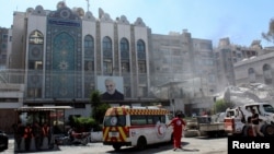 An ambulance is parked outside the Iranian consulate in Damascus after a suspected Israeli strike on April 2. 