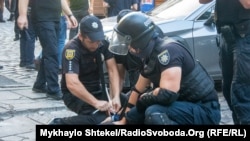 Ukrainian police detain a Tradition and Order activist in Odesa on August 28, 2021. 