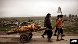 Relatives transport on carts the bodies of Iraqi residents of west Mosul who were killed in an air strike targeting Islamic State (IS) militants.