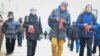 Activists distribute the red-and-white ribbons in Minsk on December 6.