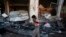 A boy reacts as he walks past the site of a bomb attack in a Shi'ite Muslim area in Quetta that killed more than 80 people. 
