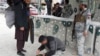 Afghan security officials check a man at Torkham border crossing in March following a previous closure.