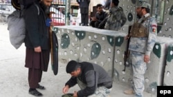 Afghan security officials check a man at Torkham border crossing in March following a previous closure.