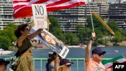 Demonstrators hold signs during a rally in support of the Iranian people and to condemn the execution of political prisoners in Iran. (file photo)