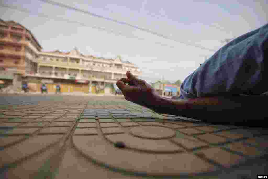 A wounded man is seen on the ground during clashes between garment workers and security forces in Phnom Penh, Cambodia, on January 3. (Reuters/Samrang Pring)