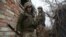 Ukrainian servicemen hold a position on the front line with Russia-backed separatists near the small city of Marinka in the Donetsk region on April 12. Nearly 30 Ukrainian soldiers have been reported killed since the start of the year.