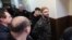 Andriy Antonenko is led by police officers to a court hearing in Kyiv earlier this year. 