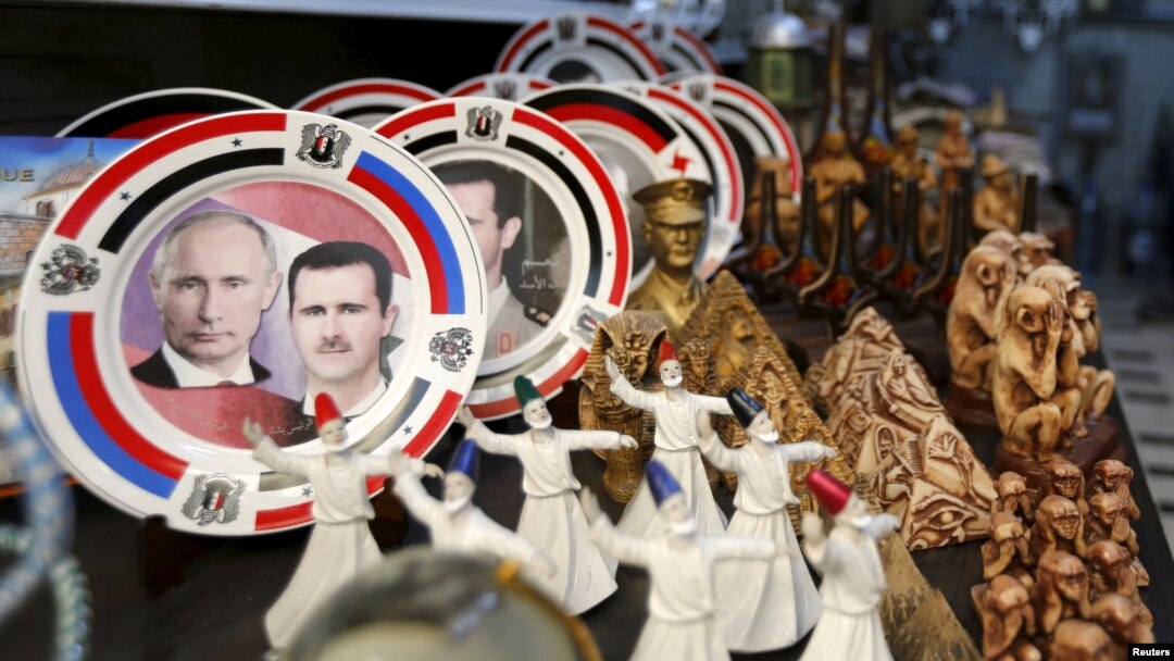 Souvenir plates depicting Syrian President Bashar al-Assad and Russian President Vladimir Putin are seen among other items for sale in old Damascus. How closely the two are coordinating future plans is hard to guess, however.