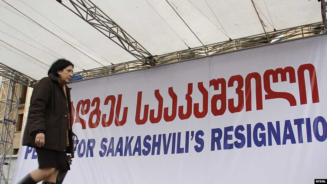 Opposition leader Salome Zurabishvili, passes a banner calling for President Mikheil Saakashvili's resignation.