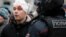 An injured protester looks on as riot police disperse anti-government protests in Moscow on January 23.