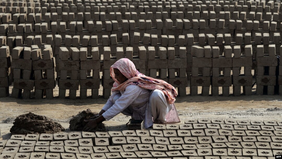 A female laborer makes bricks at a factory on the outskirts of Lahore. (file photo)