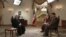 Iranian President Hassan Rohani (left) during an interview broadcast live on state television in Tehran on February 5.