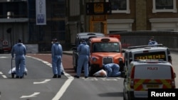 Forensics investigators work on London Bridge after attackers rammed a hired van into pedestrians and stabbed others nearby killing eight and injuring dozens. 