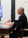 In this pool photograph distributed by the Russian state agency Sputnik, Russia's President Vladimir Putin chairs a Security Council meeting via a videoconference at the Kremlin in Moscow on November 14, 2025. (Photo by Gavriil Grigorov / POOL / AFP)