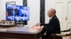 In this pool photograph distributed by the Russian state agency Sputnik, Russia's President Vladimir Putin chairs a Security Council meeting via a videoconference at the Kremlin in Moscow on November 14, 2025. (Photo by Gavriil Grigorov / POOL / AFP)