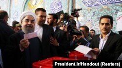 Iran's President Hassan Rouhani casts his ballot during the presidential election in Tehran on May 19.