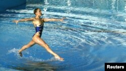 FILE PHOTO:A member of the Ukrainian synchronised swimming team performs its free routine during an Olympic Games qualification tournament at the Olympic Aquatic Centre of the Athens Olympic Sports Complex (OAKA) April 17, 2004. REUTERS/Yannis Behrakis/