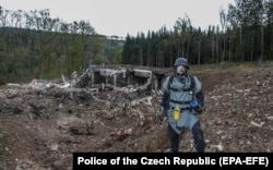 A technician inspects the remains of the ammunition depot near Vrbetice in the eastern Czech Republic, in October 2014.