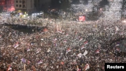 Studenti i antivladini demonstranti sa upaljenim svetlima na mobilnim telefonima tokom velikog protesta 15. marta 2025. u Beogradu