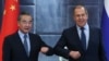 Chinese Foreign Minister Wang Yi (left) and Russian Foreign Minister Sergei Lavrov greet each other during their meeting on the sidelines of a meeting in Dushanbe in 2021.