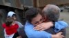 Armenia - Ethnic Armenians who fled Nagorno-Karabakh embrace upon their arrival in Kornidzor, September 26, 2023. (Stepan Poghosyan/PHOTOLUR Photo via AP)