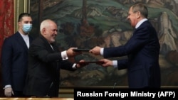 Russian Foreign Minister Sergei Lavrov and his Iranian counterpart, Mohammad Javad Zarif, attend a signing ceremony following their meeting in Moscow on June 16.
