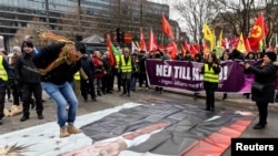 Protesters demonstrate against Turkish President Recep Tayyip Erdogan and Sweden's NATO bid in a rally arranged by the Kurdish Democratic Society Center in Stockholm on January 21. 