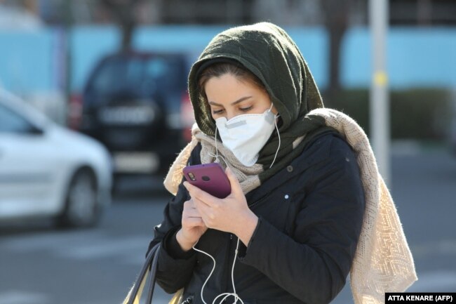 An Iranian woman checks messages on her smart phone in Tehran. “It’s like [authorities] are determined to fight the people.... [They] are happy about the torment they are inflicting on Iran," said Saeedeh Khashi, who lives in Sistan-Baluchistan, one of Iran’s poorest provinces. (file photo)