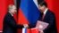 Russian President Vladimir Putin (left) and Chinese counterpart Xi Jinping shake hands after signing an agreement during a bilateral meeting in Shanghai on May 20.