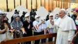 POPE-IRAQ/CHALDEAN CATHEDRAL/Pope Francis greets people as he arrives to hold a Mass at the Chaldean Cathedral of "Saint Joseph" in Baghdad, Iraq March 6, 2021.