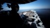 A U.S sailor keeps watch from the captain's bridge in the Strait of Hormuz.