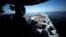 A U.S sailor keeps watch from the captain's bridge in the Strait of Hormuz.