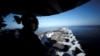 A U.S sailor keeps watch from the captain's bridge onboard the USS John C. Stennis as it makes its way to the Gulf through the Strait of Hormuz, December 21, 2018.