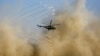 A military helicopter flies during the joint Russian, Tajik, and Uzbek drills at Tajikistan&#39;s Harb-Maidon firing range on August 10.