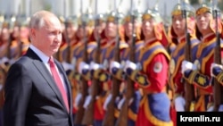 Russian President Vladimir Putin inspects a guard of honor while visiting Mongolia on September 3. 