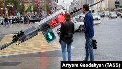 A traffic light leans at a steep angle in central Moscow after a heavy storm on May 29.