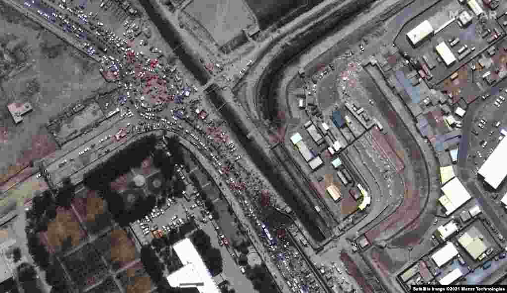 An aerial image shows large crowds gathered outside Kabul&#39;s international airport amid evacuations on August 23.