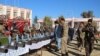 Afghan security officials display weapons and ammunition seized during recent operations against Taliban militants in Helmand on January 26.