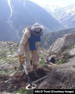 A civilian deminer from HALO Trust uses a metal detector to search for Soviet-era landmines and unexploded ordnance in the mountains of Afghanistan.