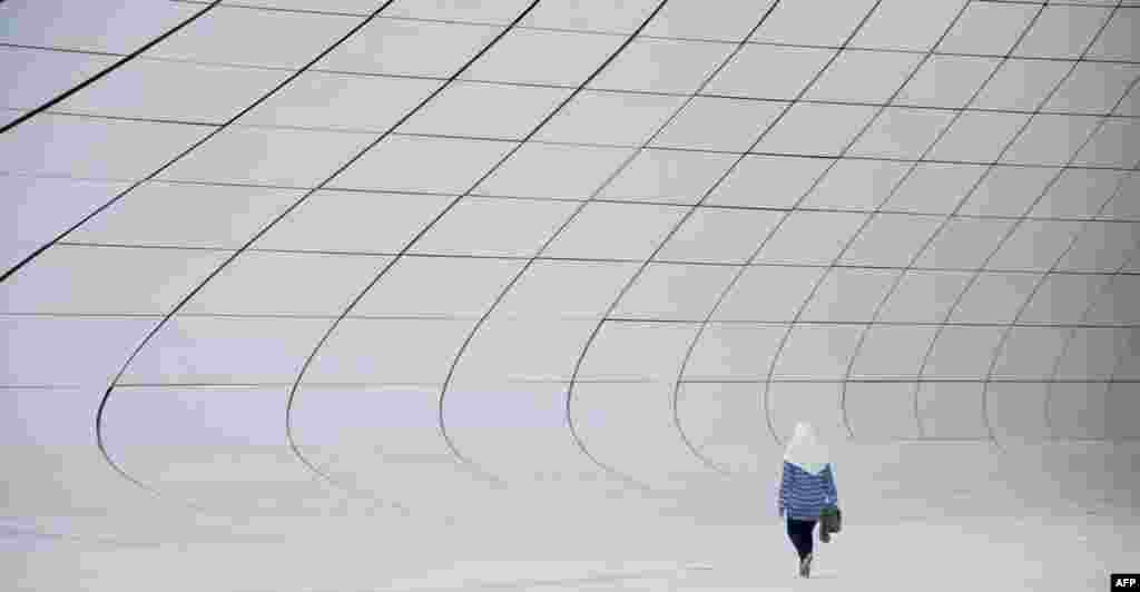 A woman walks outside the Heydar Aliyev Center in Baku ahead of the 2015 European Games, which will run from June 12-28. (AFP/Tobias Schwarz)