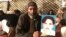 A member of the Pashtun community in Islamabad holds a picture of Naqibullah Mehsud, whose extrajudicial killing by Karachi police sparked nationwide protests.