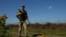 Ukraine - a guard along the border with Romania, where some draft dodgers and deserters try to leave Ukraine illegally - screen grab