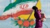 A mural of Iran’s national flag on a street in Tehran earlier this month. Some hard-liners in the country have warned the government not to repeat the mistakes of the past by negotiating with the United States.