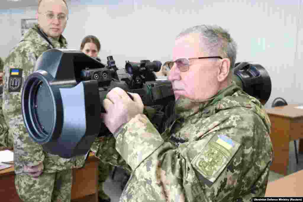 A senior Ukrainian military official holds one of the anti-tank weapons supplied by Britain during a training session for Ukrainian servicemen in Lviv.&nbsp;