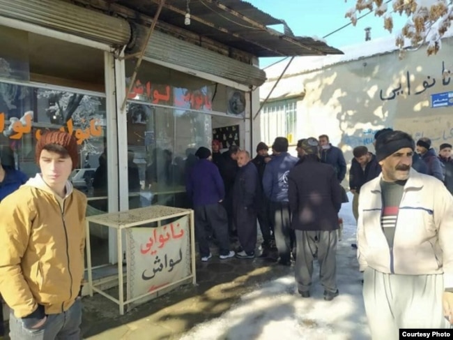 Iranians lining up to buy bread at a bakery in Sanandaj.