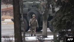 A serviceman patrols a street in central Almaty on January 8 following violence that erupted after protests over hikes in fuel prices. 