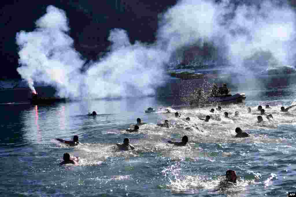 Kosovo Serbs swim in the cold water of Gazivoda Lake as part of a traditional Orthodox Epiphany swimming competition, near the town of Zubin Potok in northern Mitrovica.&nbsp;