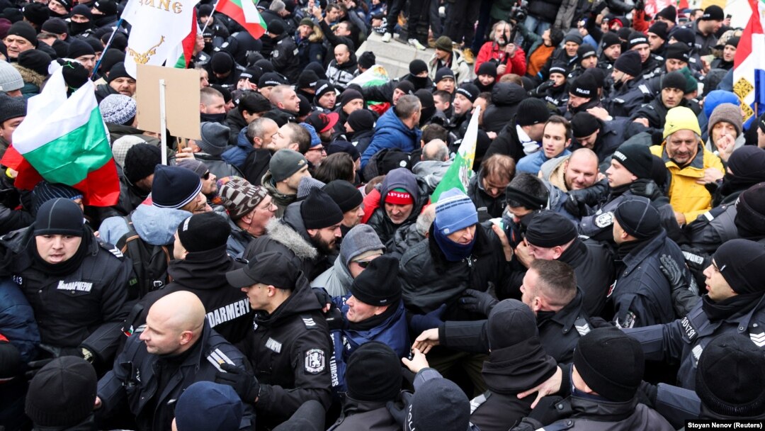 Protesters scuffle with police as they try to enter Bulgaria's parliament building during a rally in Sofia against government measures to curb the spread of the coronavirus on January 12. 