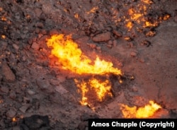 A vent in the crater spews fire.