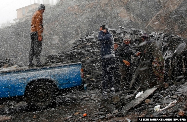 Afghan workers on a snowy day in the city of Meygun, north of Tehran, in January.